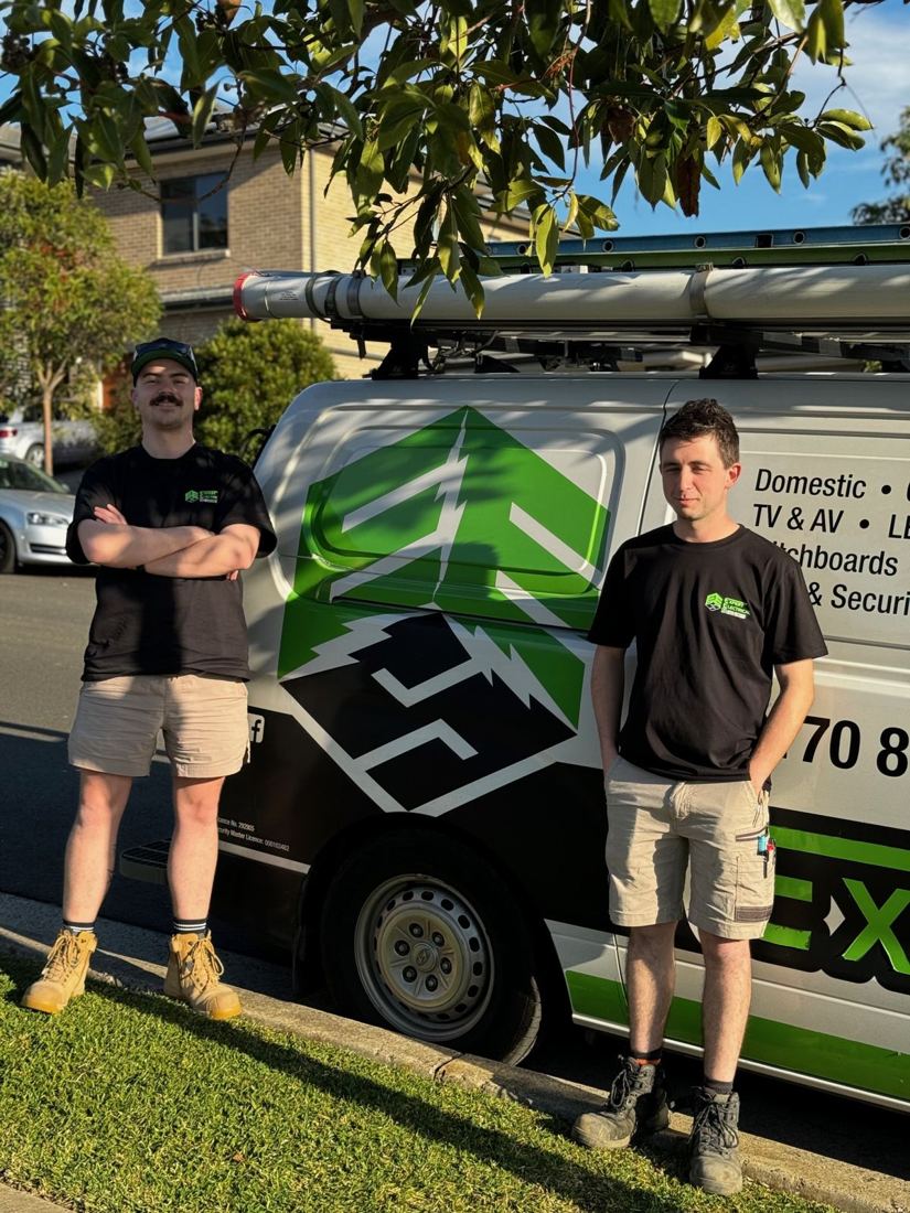 The Expert Electrical Services team beside their van