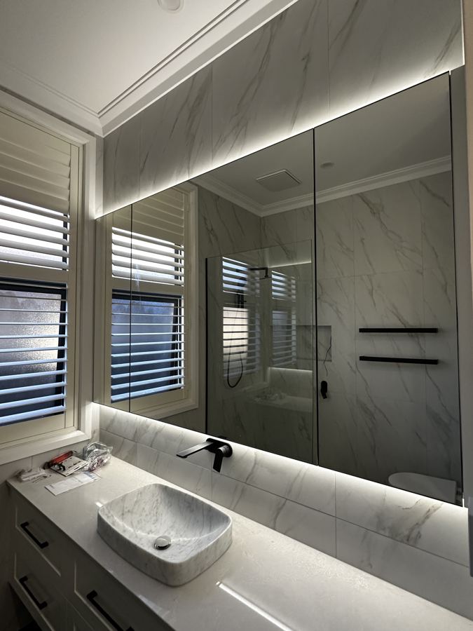 Bathroom with backlit LED mirror
